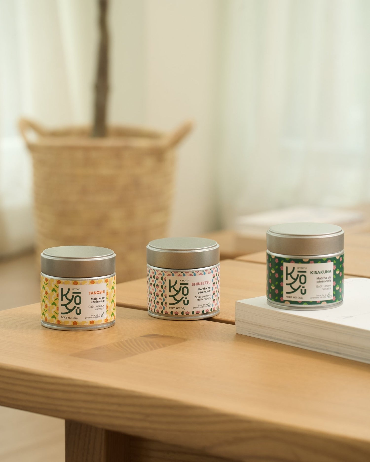 Image des trois matcha cérémoniaux Kyoyu posés sur une table en bois : Kisakuna, Tanoshi et Shinsetsu, chacun dans son emballage élégant.